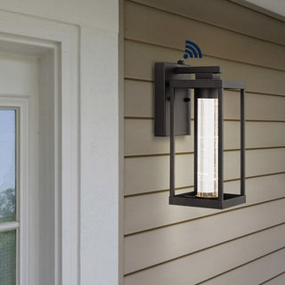 Shoji 4.75" Industrial Vintage Iron/Glass Seeded Glass with Dusk-to-Dawn Sensor Integrated LED Outdoor Sconce