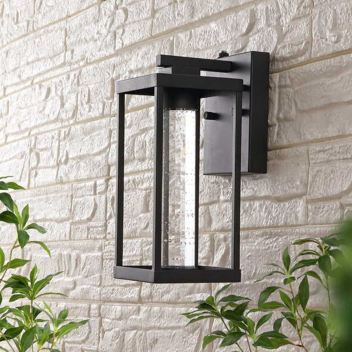 Shoji 4.75" Industrial Vintage Iron/Glass Seeded Glass with Dusk-to-Dawn Sensor Integrated LED Outdoor Sconce