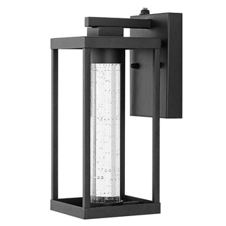 Shoji 4.75" Industrial Vintage Iron/Glass Seeded Glass with Dusk-to-Dawn Sensor Integrated LED Outdoor Sconce